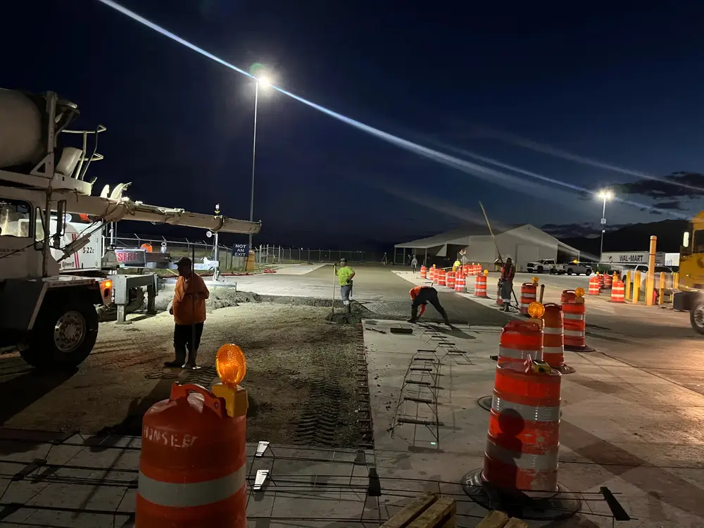 B Hansen Construction crew placing concrete at a Walmart site at night